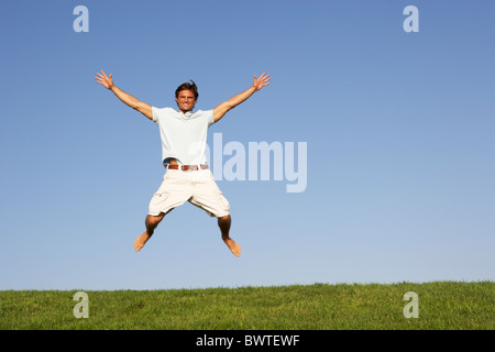 Young man jumping in air Stock Photo