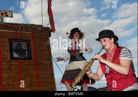 A travelling troupe of actors and musicians entertain a crowd on the final day of Bestival 2010 in Newport, Isle of Wight, Stock Photo