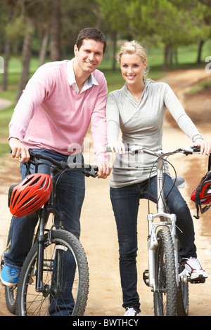 Young couple running together in park Stock Photo