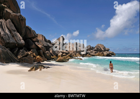 Woman on the beach of Grand Anse, La Digue, Seychelles Stock Photo