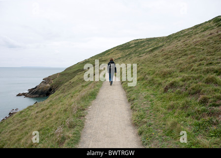 A walker on the South West Coastal Path at Baggy Point, Croyde, North Devon, England, UK. Stock Photo