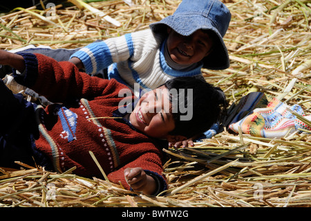 Kids playing on the Floating Islands of Lake Titicaca, which are originally made of reeds by the Uros people. Stock Photo