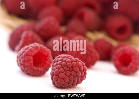 Fresh raspberry in and outside of a basket Stock Photo