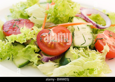 Fresh garden salad with tomato, cucumber and lettuce as closeup Stock Photo