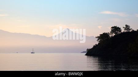 Early morning wispy clouds over Fethiye Bay Turkey with Baba Dagi mountain on the horizon Stock Photo