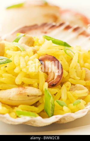 Spicy jasmine rice in shell as closeup on white background Stock Photo