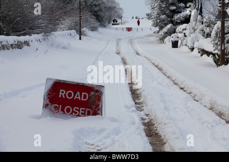 Road closed sign on Ringinglow road in Sheffield after a very heavy snow fall Stock Photo