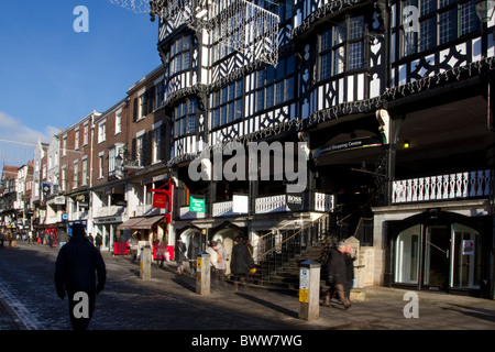 Chester walled cathedral city centre;  The Rows pedestrianised streets, businesses, shops, shoppers, galleries and buildings in Eastgate, UK Stock Photo