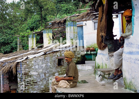 Sikh men relaxing while having a cigarette outside their house, Mount Abu, Rajasthan, India. Stock Photo