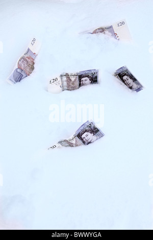 Five £20 notes lying in the snow Stock Photo