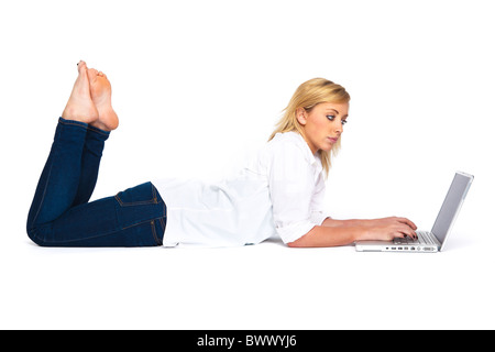 Beautiful Young Woman Using Her Laptop Lying Down in Profile Stock Photo