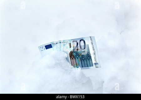 €20 Euro notes in the snow or ice Stock Photo