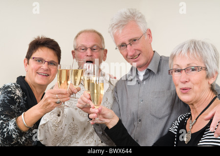 Two senior couples toasting on a Happy New Year. Stock Photo