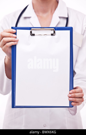Doctor holds clipboard with empty sheet. Isolated on a white. Stock Photo