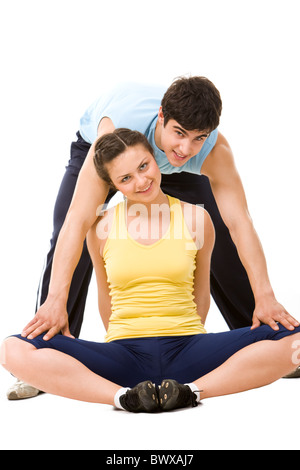 Photo of pretty young woman and sports instructor looking at camera during workout Stock Photo