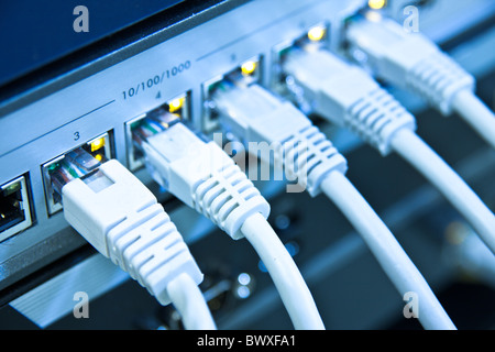 network cables RJ45 connected to a switch Stock Photo