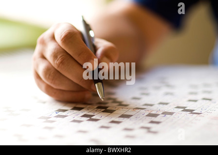 doing cross word puzzle Stock Photo