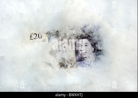 BRITISH TWENTY POUND NOTE IN SNOW AND ICE RE WINTER FUEL PAYMENTS SAVINGS CASH MONEY INVESTMENTS MORTGAGES ETC Stock Photo