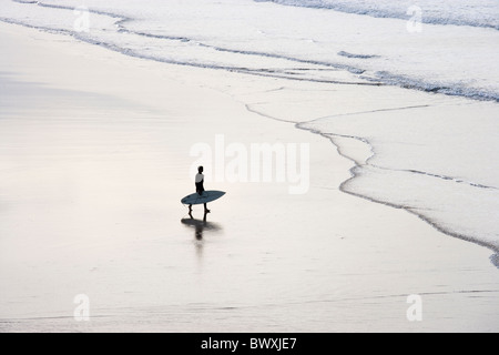 Surfer on beach, Godrevy, Cornwall, UK Stock Photo