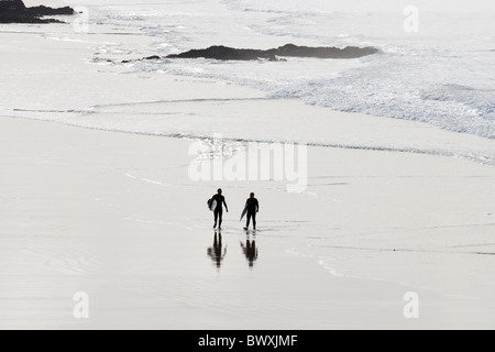Surfers on beach, Godrevy, Cornwall, UK Stock Photo