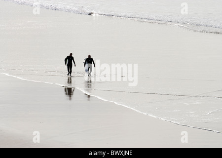 Surfers on beach, Godrevy, Cornwall, UK Stock Photo