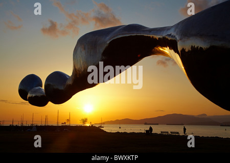 Sculpture 'Freezing Water #7' by artist Jun Ren of China, Vanier Park, and sunset across English Bay, Vancouver, Canada Stock Photo