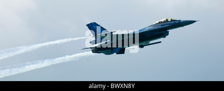 Belgian F-16A F16 Eastbourne Airbourne Airshow Air Show in flight travelling left to right trailing smoke - cockpit visible Stock Photo