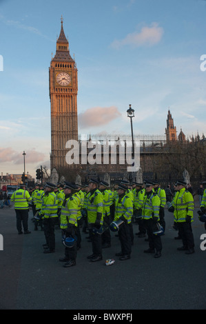 Police officers protecting the Houses of Parliament during a demonstration by students in London. Stock Photo