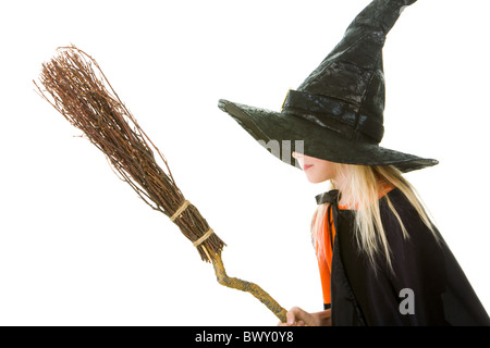 Photo of girl in witch costume holding broom Stock Photo