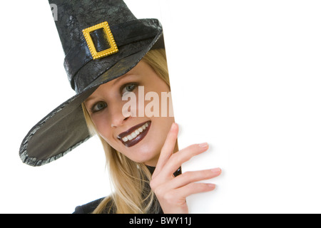 Halloween witch looking out of board with your advert Stock Photo