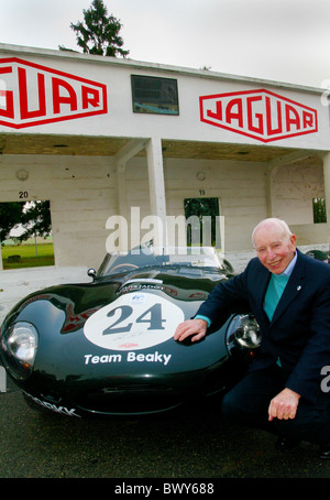 John Surtees beside a reproduction D-type Jaguar at Reims-Gueux in France Stock Photo