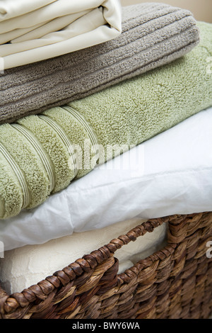 Basket with Folded Towels and Sheets Stock Photo