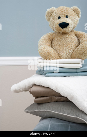 Stack of Linens and Teddy Bear Stock Photo