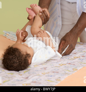 Father Changing Baby's Diaper Stock Photo