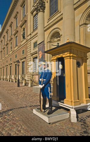 EUROPE SWEDEN Stockholm guard on duty outside Royal Palace with Storkyrkan Royal Lutheran Cathedral of Sweden at rear Stock Photo