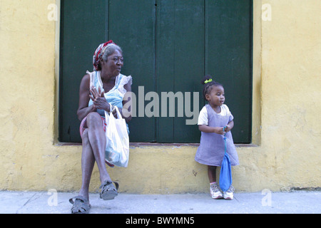 granddaughter facade shutter grandmother Havana child Cuba Caribbean girl person senior citizen situation Stock Photo