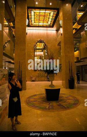 Interior of The Kowloon Regal Hotel, Hong Kong, huge mirrors and stained glass decorate the main entrance Stock Photo