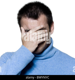 studio portrait on isolated background of a stubble man crying sad depression Stock Photo