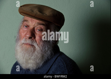 Isolated portrait of caucasian old man with long white beard wearing an hat Stock Photo