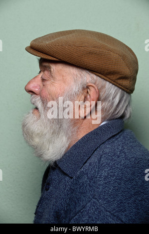 Isolated portrait of caucasian old man with long white beard wearing an hat Stock Photo