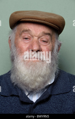 Isolated portrait of caucasian old man with long white beard wearing an hat Stock Photo