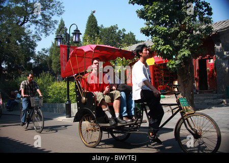 Rickshaw drivers take tourists for Hutong tour, Beijing, China Stock Photo