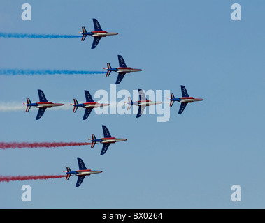 Patrouille De France French Display Alpha Jets flying left to right in arrow formation with red blue and white smoke trails Stock Photo