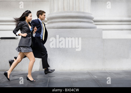 Business people running on sidewalk Stock Photo