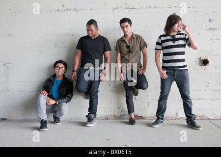 Teenage boys leaning against wall Stock Photo