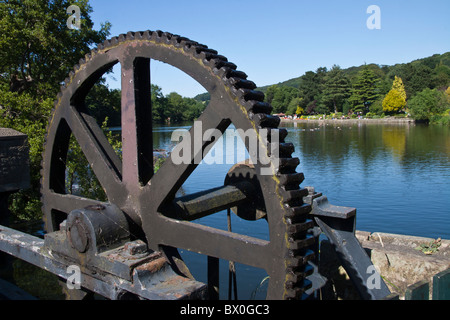 Sluice gate machinery at the East Mill with view to Belper River Gardens and the River Derwent, Belper, Derbyshire, England Stock Photo