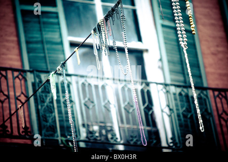 Mardi Gras beads hang on electrical/telephone wires and residents' balconies throughout the French Quarter in New Orleans, LA. Stock Photo