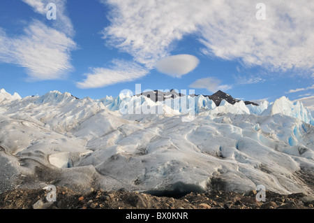Ridge of brown 'boulder clay' moraine, at the base of an ice-trek ice slope, at the terminus of the Perito Moreno Glacier, Andes Stock Photo