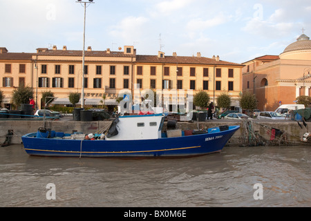 old aged fishing boat moored in canal of Tiber river in Fiumicino Rome, Mediterranean Italian European Stock Photo