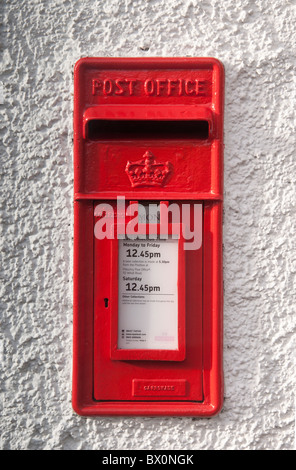 Traditional Post Box in white pebble dash wall. Stock Photo